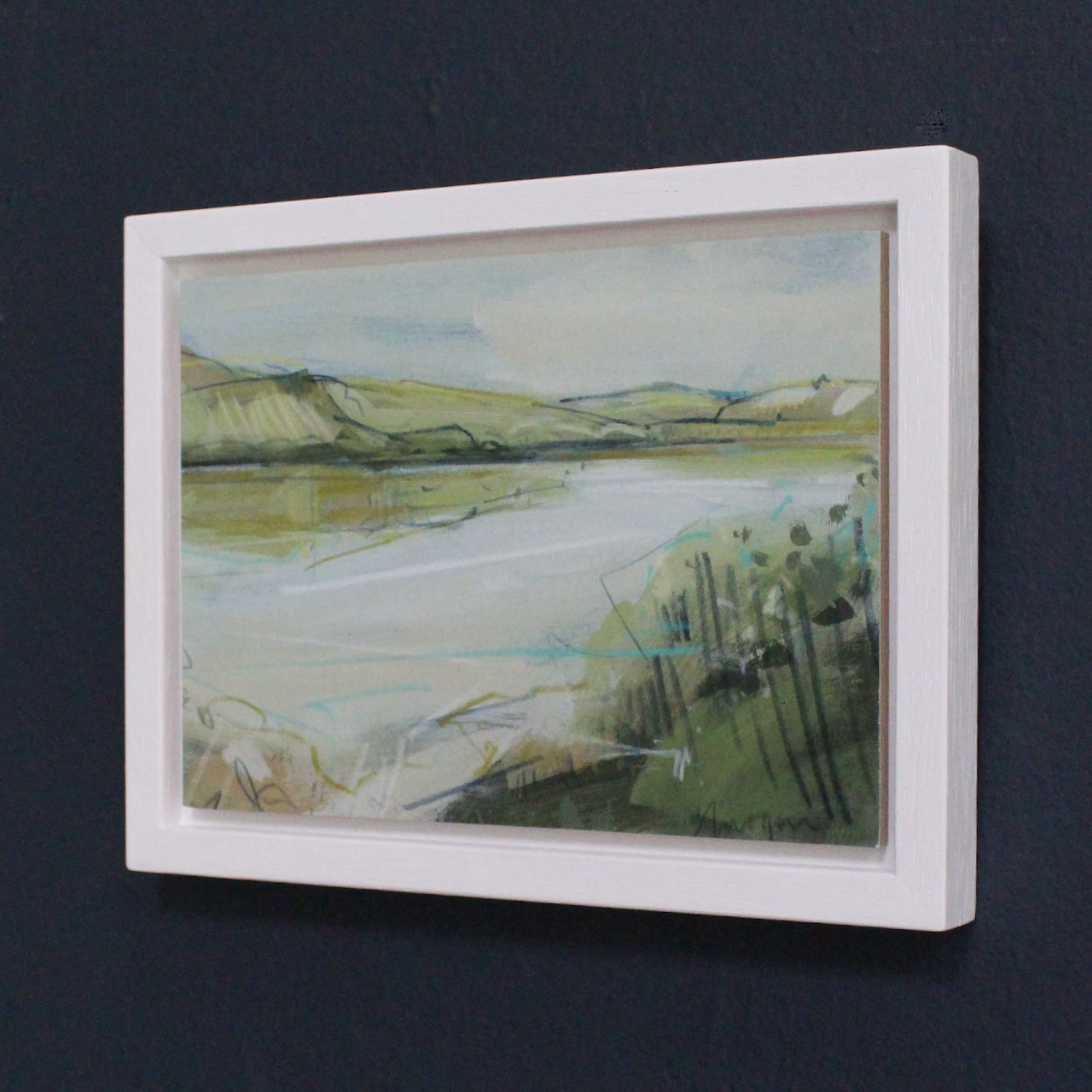 a small framed pale landscape with green hills, pale blue river by Imogen Bone, Cornish artist 