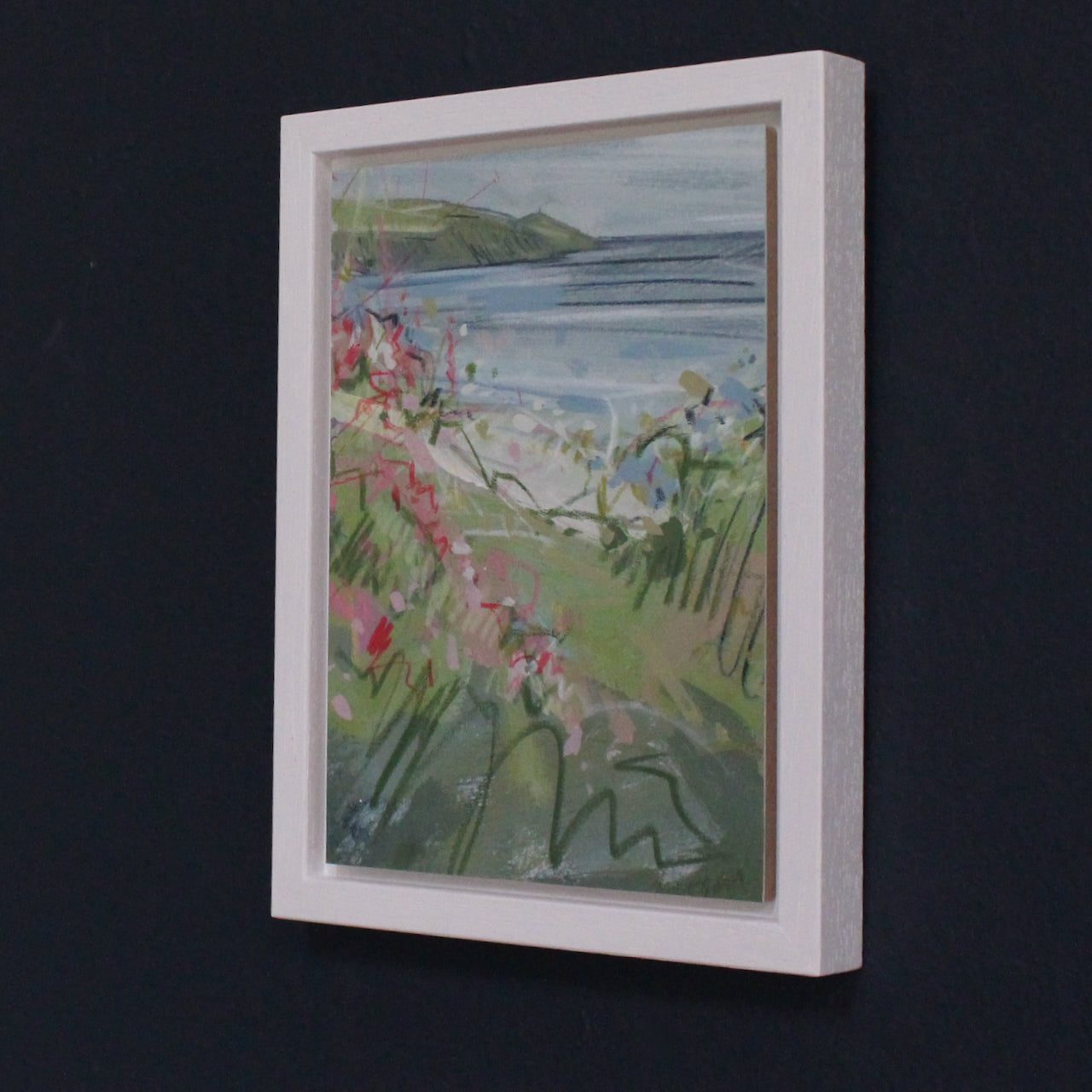 Imogen Bone, Cornish artist small painting of Rame Head in south south Cornwall the sea is blue with hints of white,  the peninsula and the hedgerow is green with pink flowers .