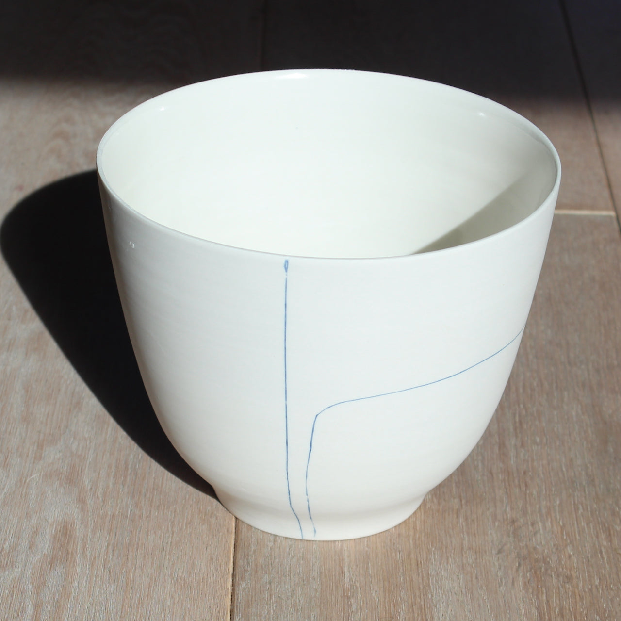 Uk potter liz o'dwyer porcelain bowl with blue line details.