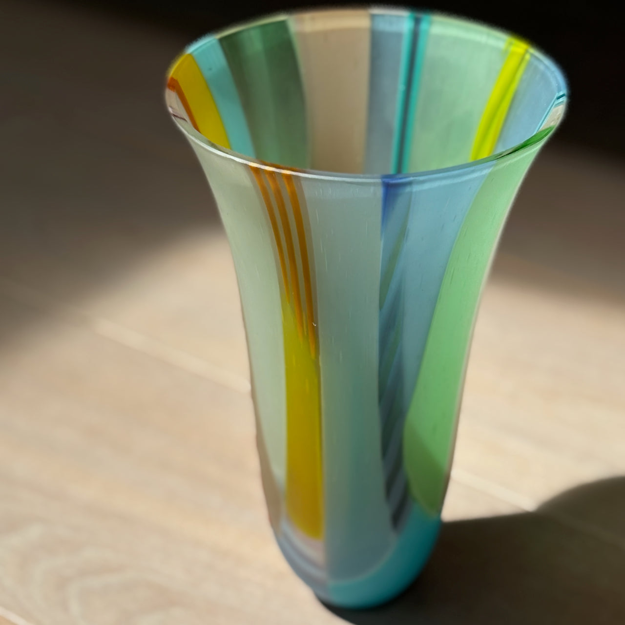 glass vessel in blues, greens and yellow by welsh glass artist Ruth Shelley