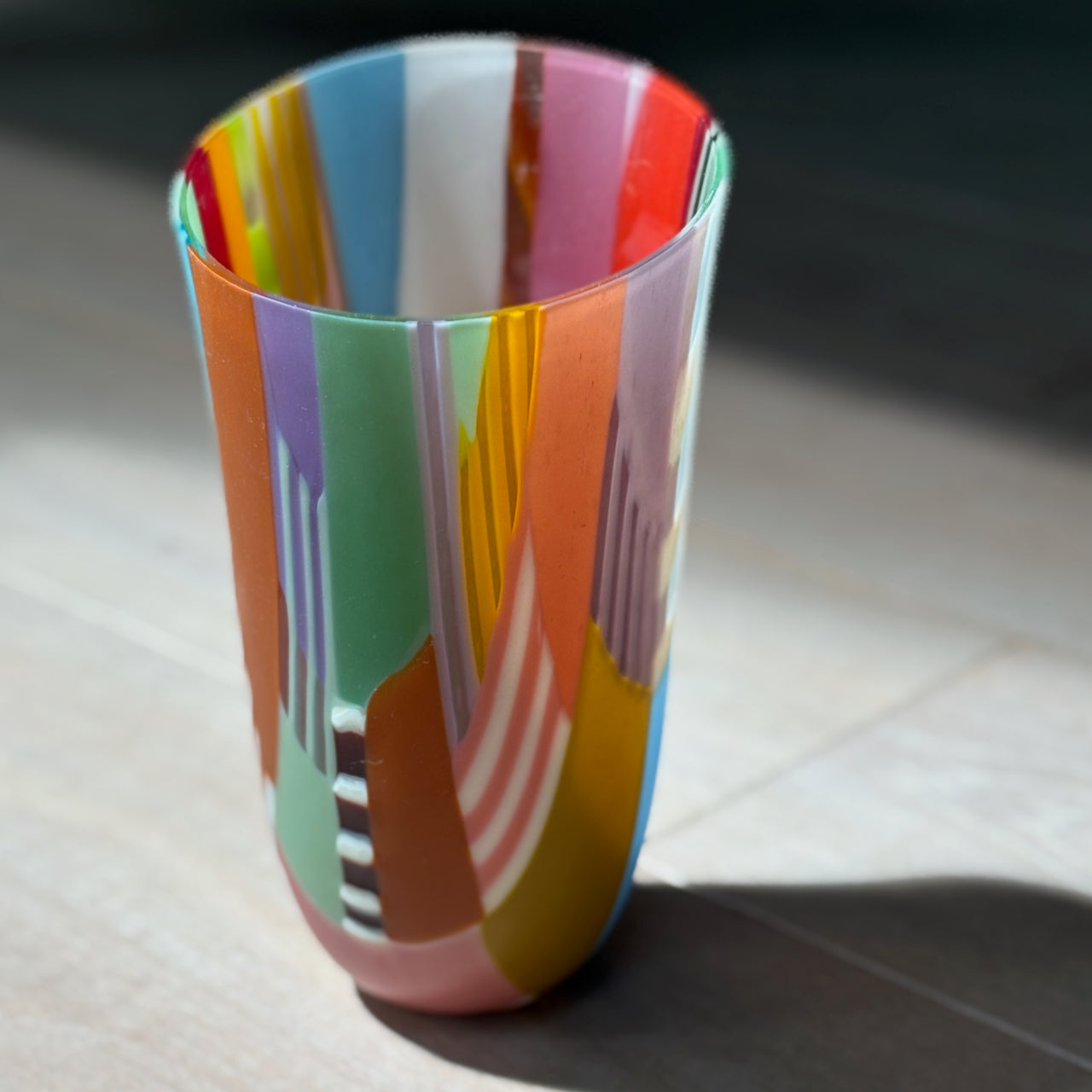 Ruth Shelly tall glass vessel in reds, greens and blues
