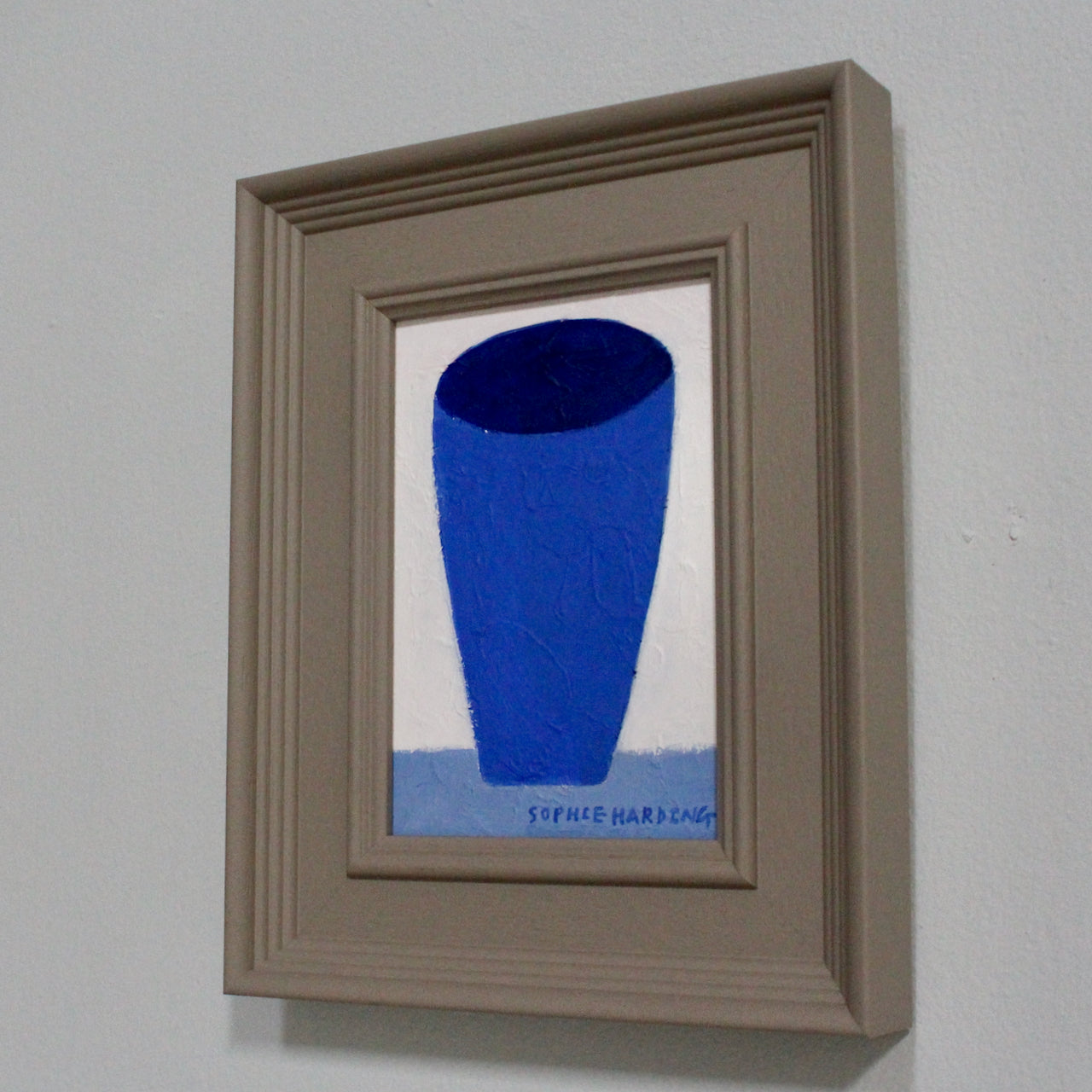 a framed painting of a blue tumbler on a white background by Cornwall artist Sophie Harding.