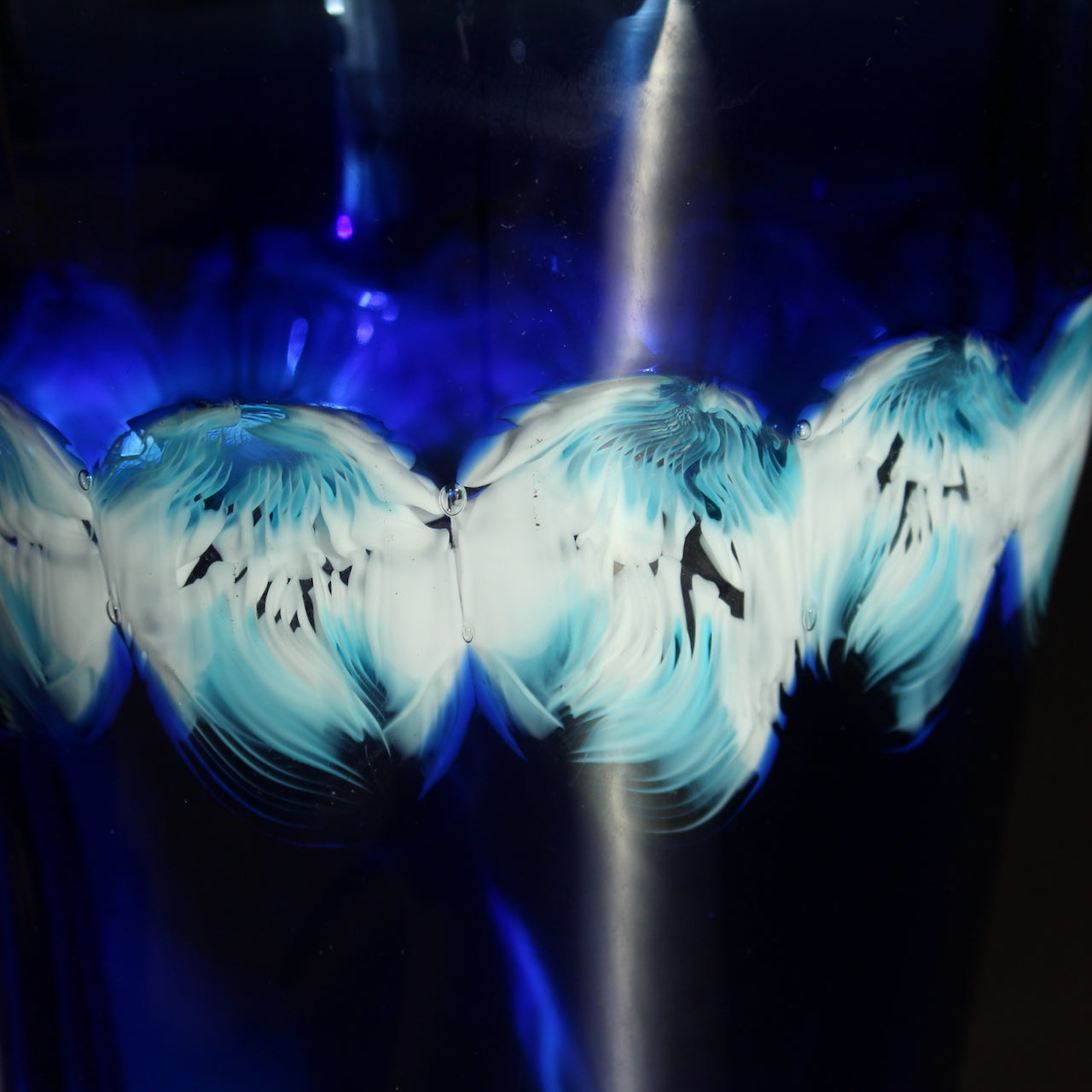 close up detail in white and turquoise in blue handblown glass vase by Benjamin Lintell it was made in Murano, the world famous centre of glass.