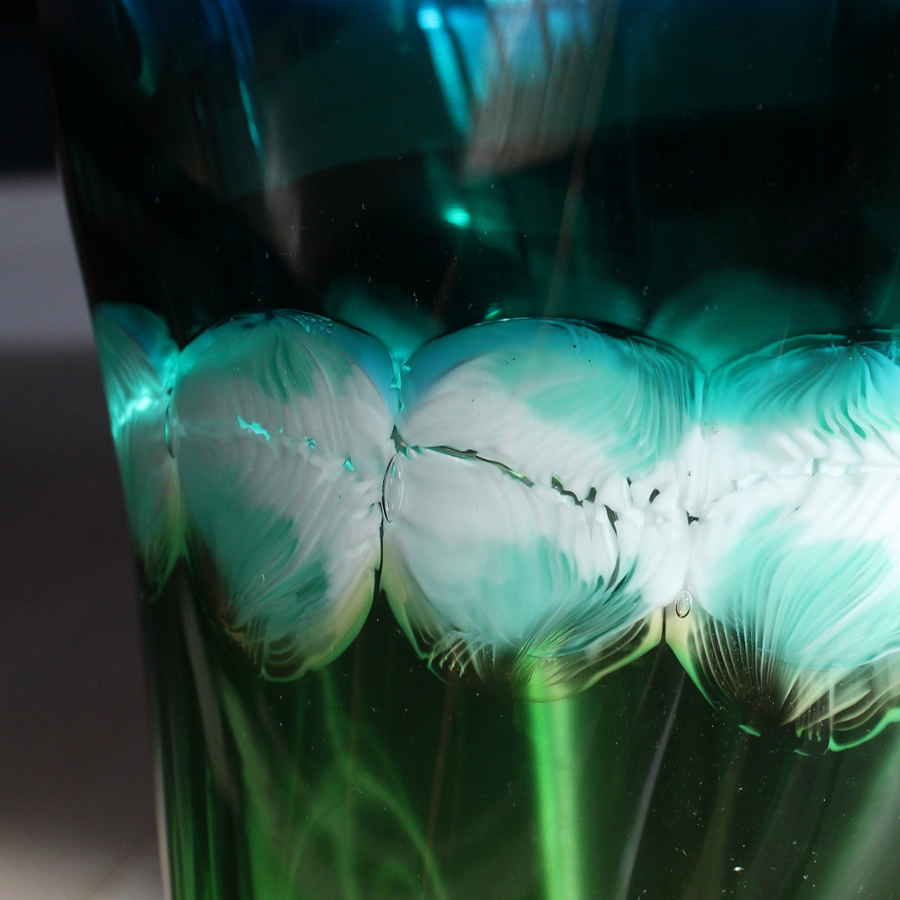 close up details in a Benjamin Lintell hand-blown glass vessel in blue, green and amber  it was designed and made by Benjamin in Murano,  Italy the glass capital of the world.