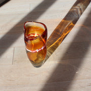 A Benjamin Lintell hand-blown glass vessel in amber with a white and red murani detail midway up, it was designed and made by Benjamin in Murano, the glass capital of the world.