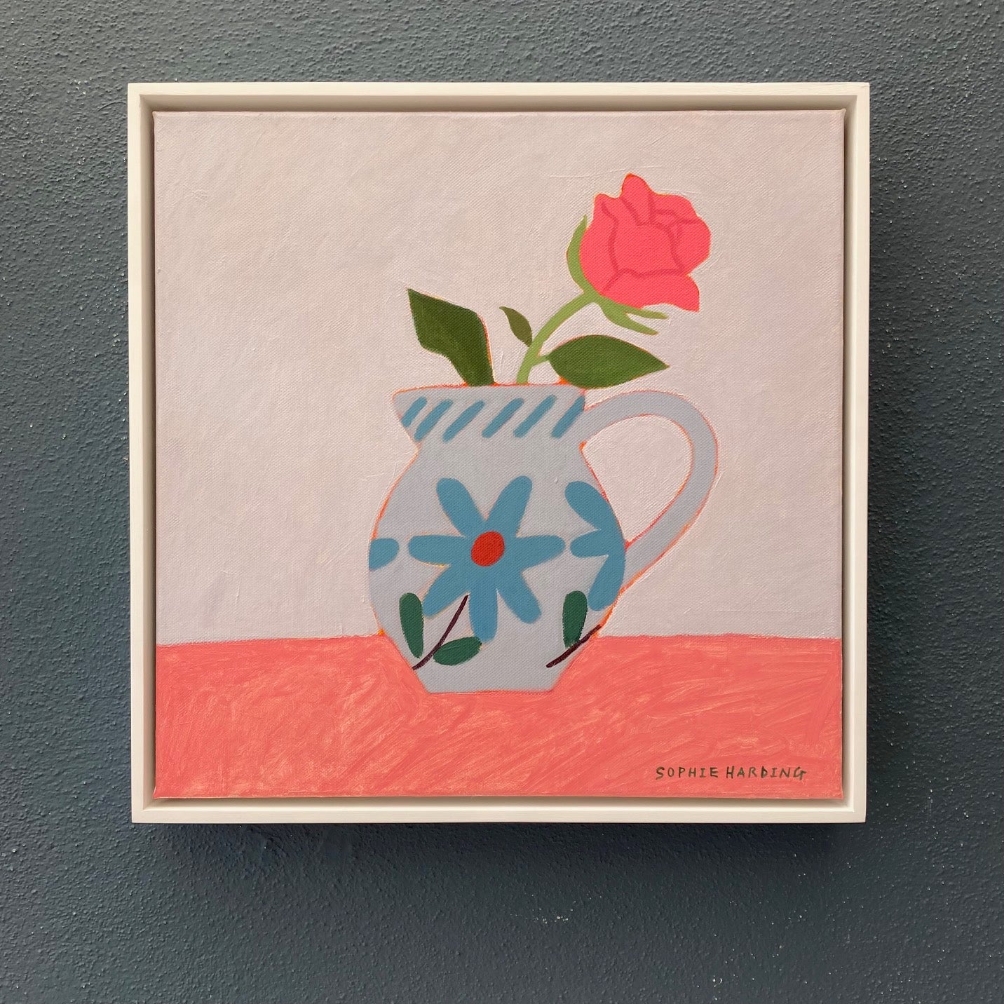 Framed artwork of a pitcher with flowers on a beige background it's by Cornwall artist Sophie Harding
