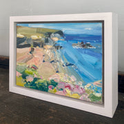 Jill Hudson painting of Rame Head in Cornwall, the headland is green with a golden beach framed by summer wildflowers; the painting is framed