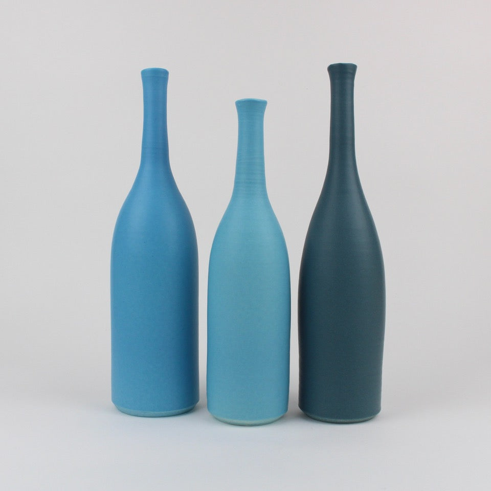 a trio of blue ceramic bottles by UK based potter Lucy Burley.