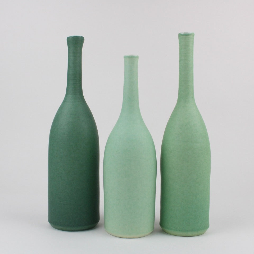 Three ceramic bottles by UK potter Lucy Burley in shades of green