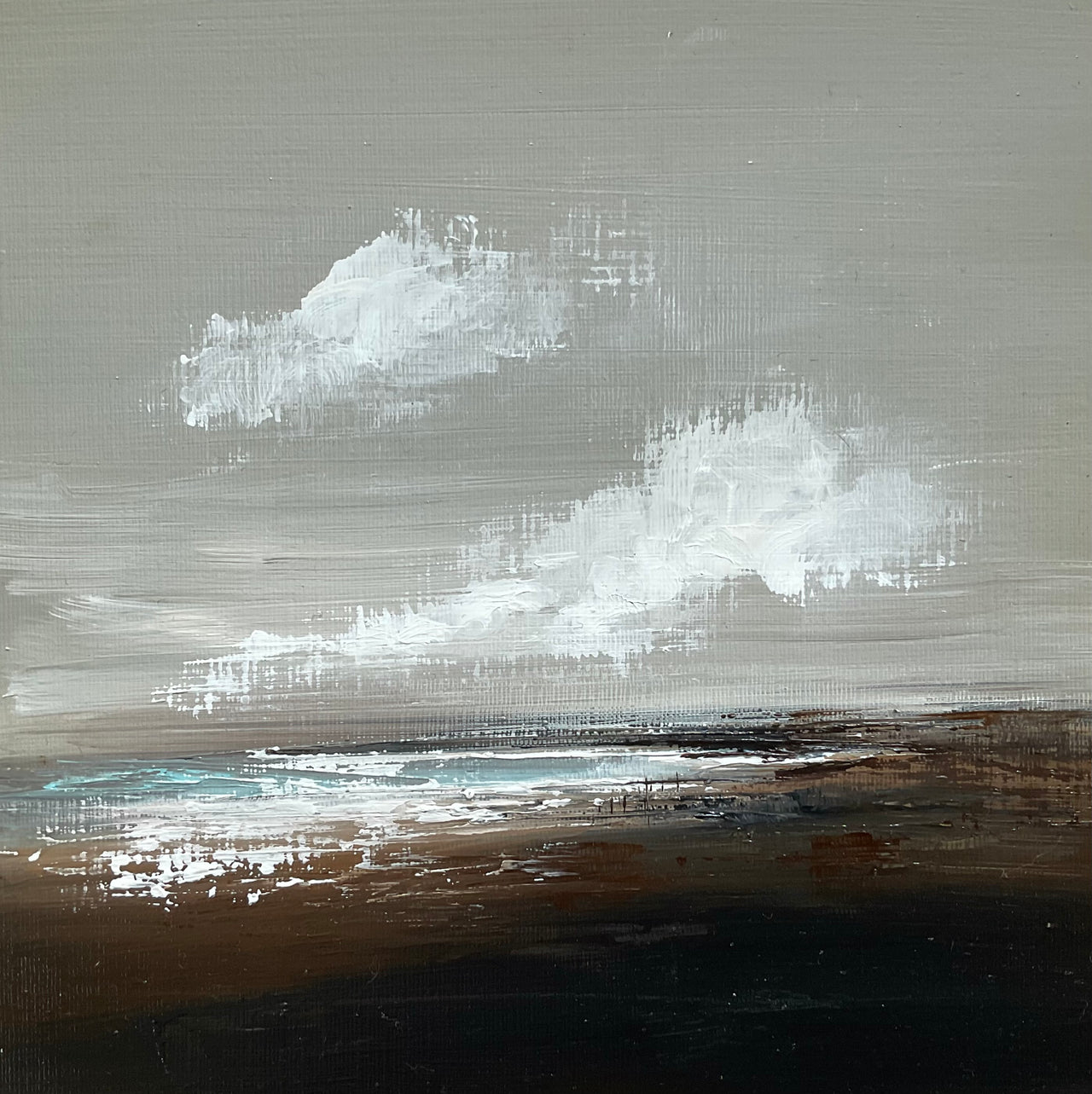 Cornish artist Nicola Mosley seascape of brown and black tones with ocean and white clouds.