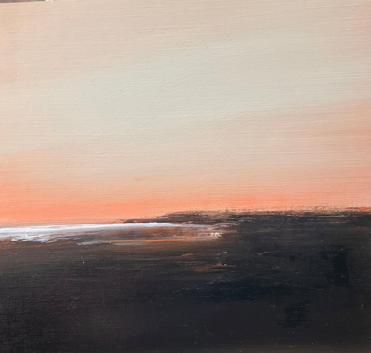 Dusky pink sky with dark tones of the landscape and white shimmering ocean by artist Nicola Mosley