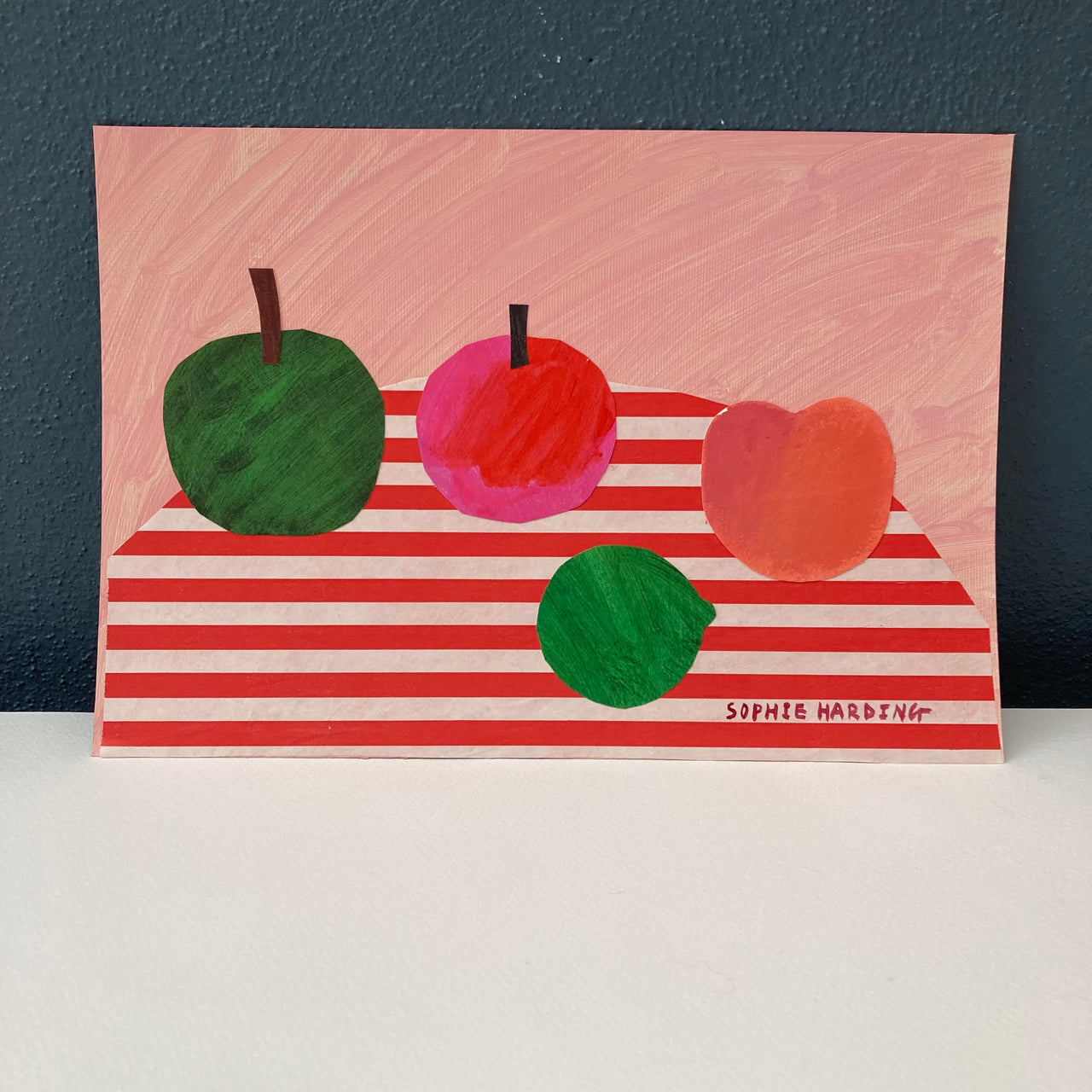 Cornish artist Sophie Harding, Green and red apples and peach on red and white stripy and pink background