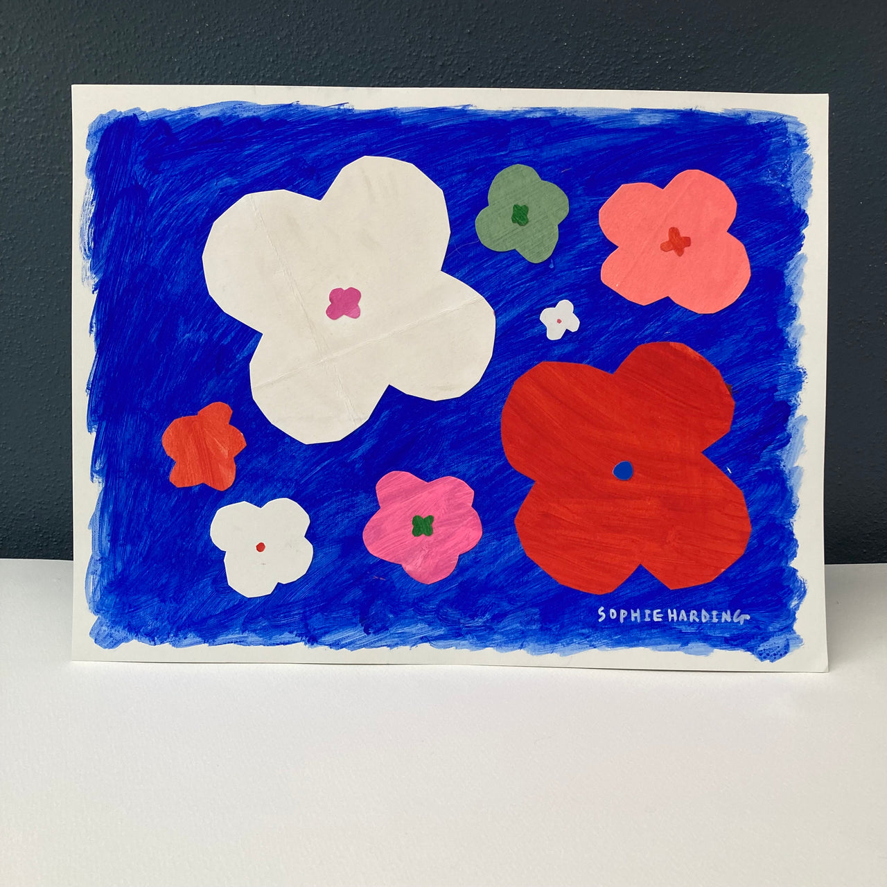 Cornish artist Sophie Harding, white, pink red and green flowers on blue background.