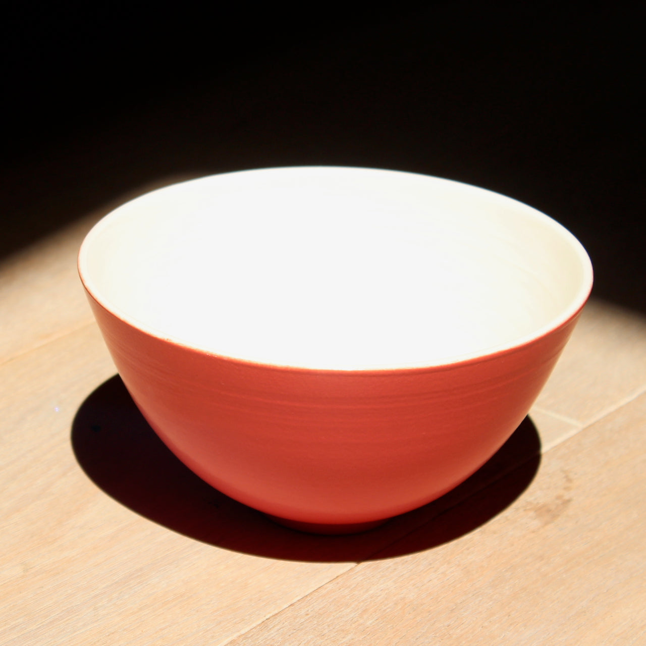 bright red Lucy Burley ceramic bowl with cream interior