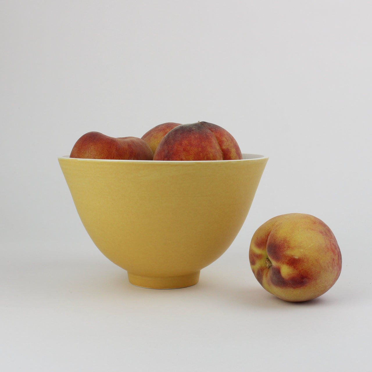 an apricot glazed ceramic bowl by UK potter lucy Burley.