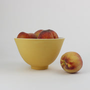 an apricot glazed ceramic bowl by UK potter lucy Burley.