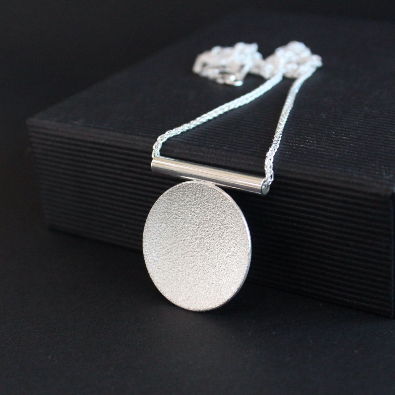 Textured silver round pendant by Beverly Bartlett
