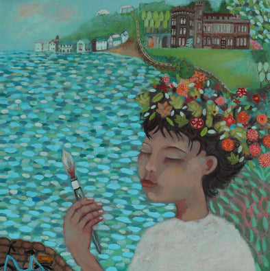 A figure with flowers in hair painting with the blue sea behind and houses, buildings on the coastline in the background by Cornish artist Siobhan Purdy