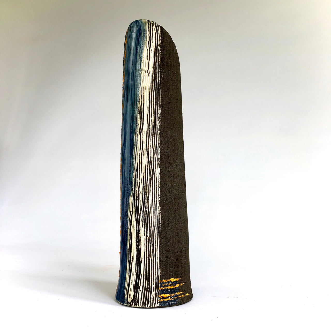 Tall dark vessel with white, blue and orange detail inspired by artist Anthea Bowen, inspired by Rame peninsula