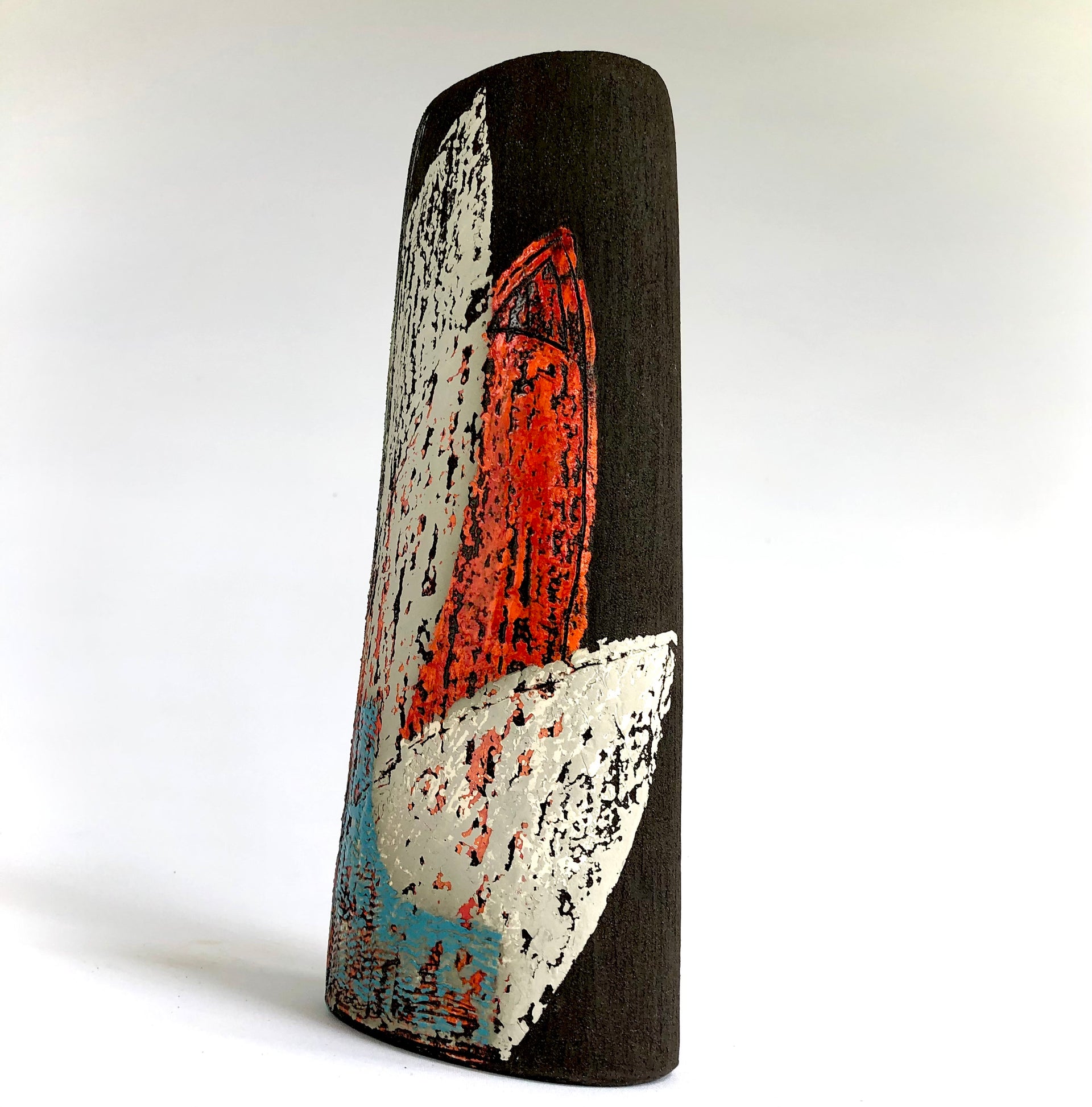 Back view of dark vessel with leaf shaped detail in blue, white and scarlet by artist Anthea Bowen