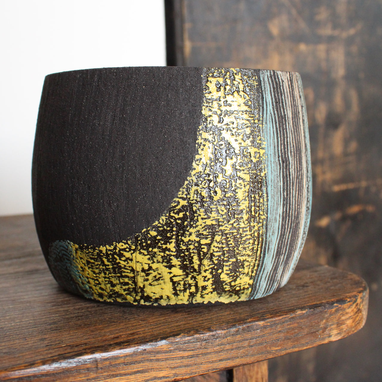 Ceramic vessel with blue, yellow and white glaze on dark brown clay by Cornish artist Anthea Bowen.