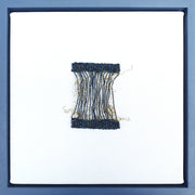 Delicate textile woven square piece in tones of blue and ochre by artist Jess Rippengale