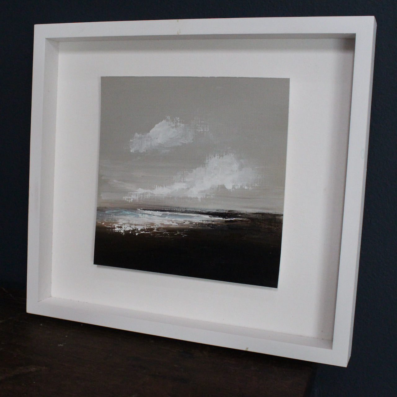 Cornish artist Nicola Mosley seascape of brown and black tones with ocean and white clouds