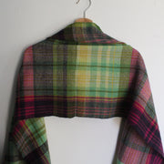 a Teresa Dunne handwoven in Cornwall scarf in green, reds and yellows.