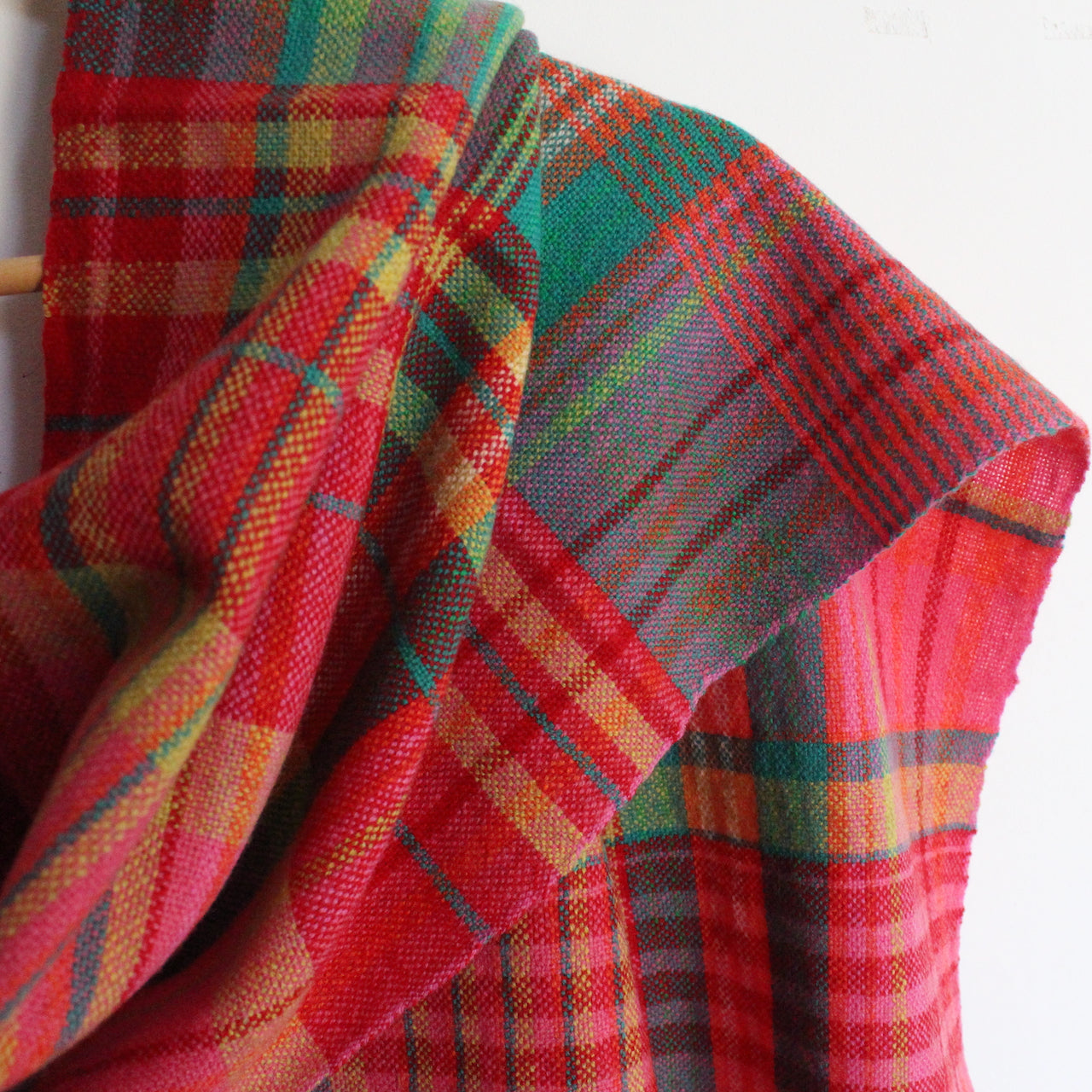 detail of a lambswool scarf in pinks, greens and yellow by Cornish textile artist Teresa Dunne