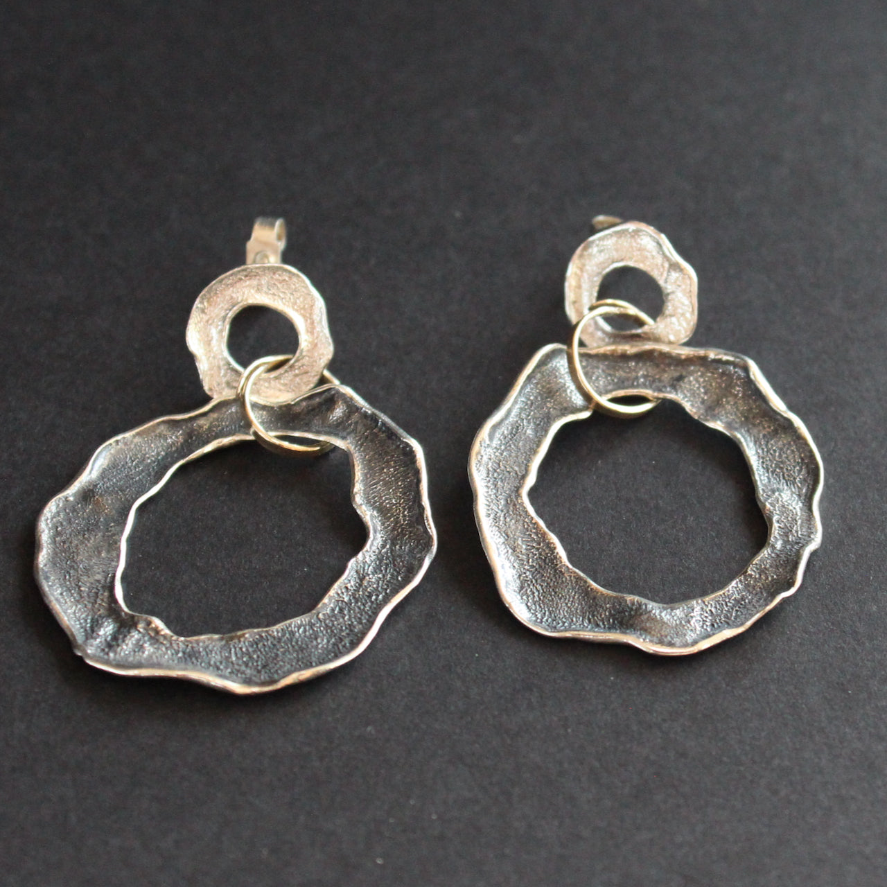 Silver flat circular stud earrings by Cornish artist Claire Stockings Baker.