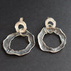 Silver flat circular stud earrings by Cornish artist Claire Stockings Baker.