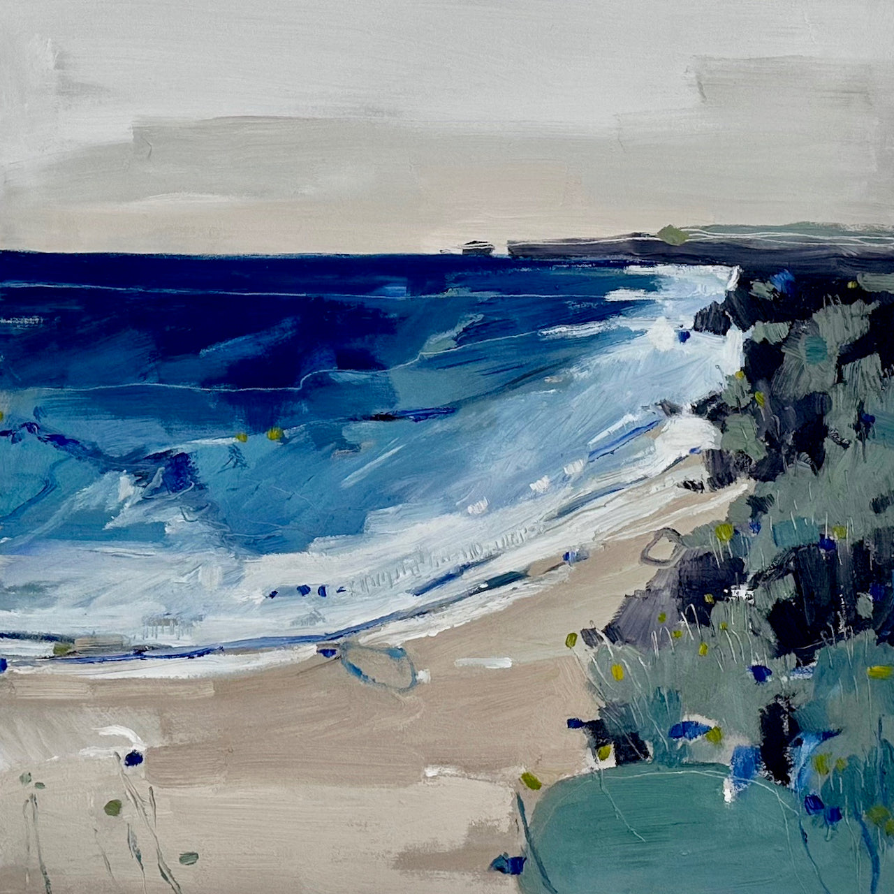 Coastal painting with sandy foreground and foliage with sea in tones of blue and white/grey sky in background by artist Aimee  Willcock