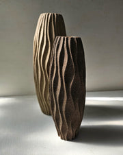 Warm grey kelp detailed vessel alongside charcoal stoneware small vessel by artist Michele Bianco