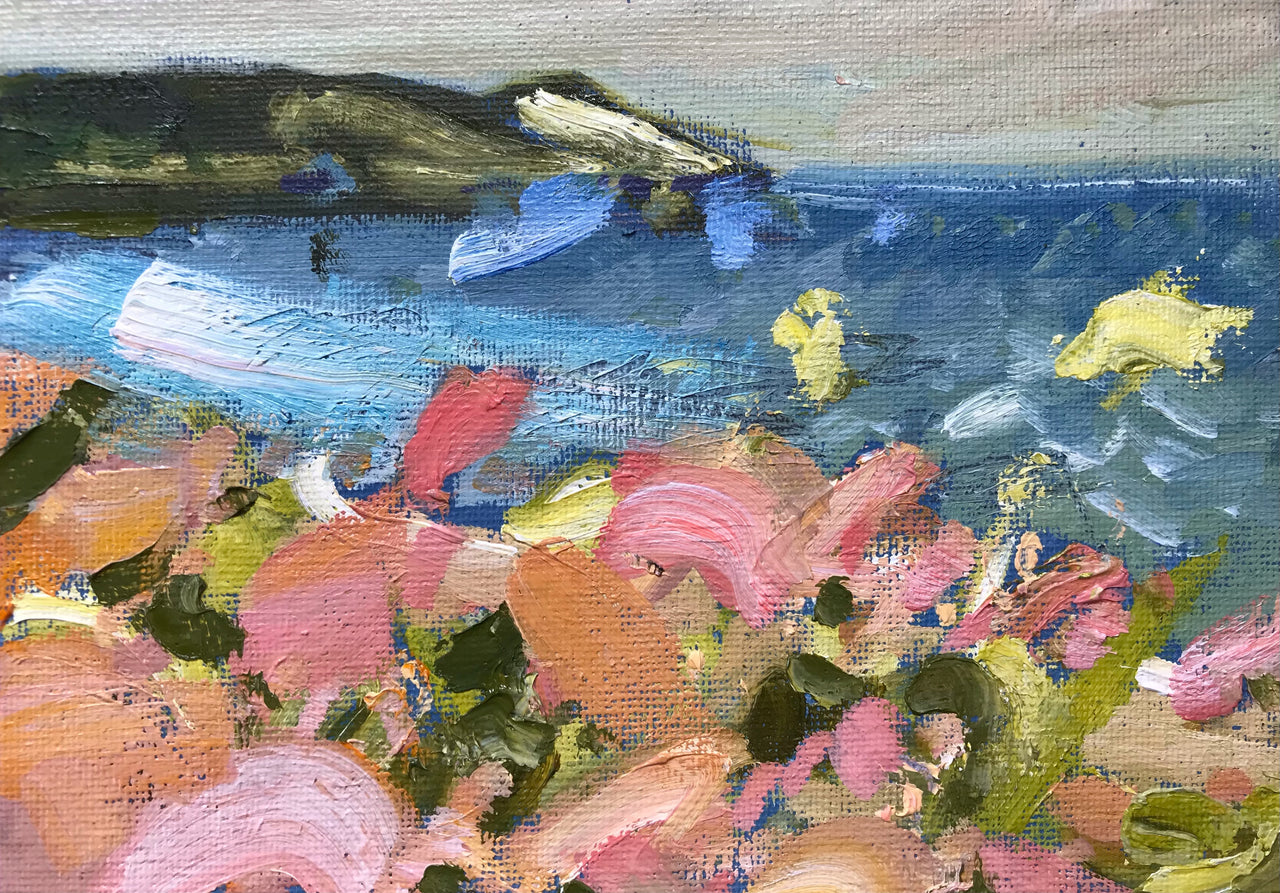 Glorious pink and cream honeysuckle in foreground with dark headland and ocean behind by artist Jill Hudson