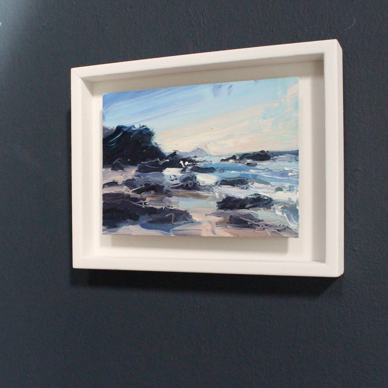 Beach painting with dark rocks by Jill Hudson with Rame Head in the background