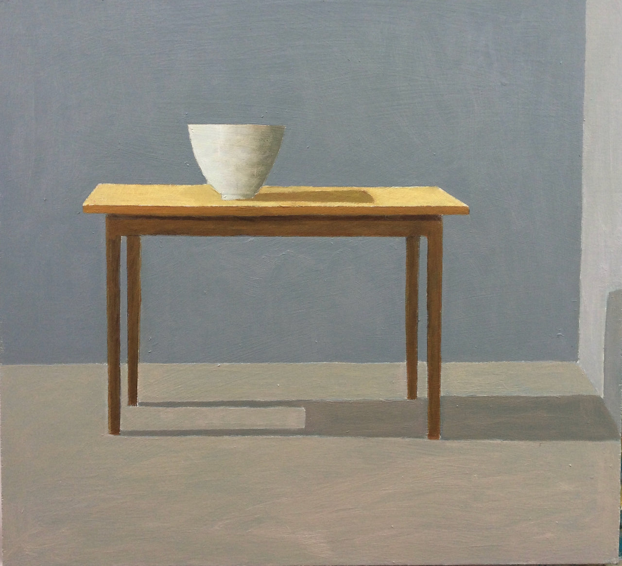 Muted wall tones with cream vessel sitting on brown table casting a shadow by artist Philip Lyons