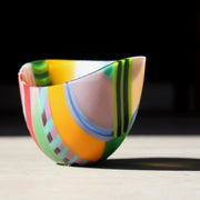 Beautiful vibrant glass bowl in tones of pink, green, yellow, blue, red by glass artist Ruth Shelley