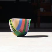 Beautiful vibrant glass bowl in tones of pink, green, yellow, blue, red by glass artist Ruth Shelley.