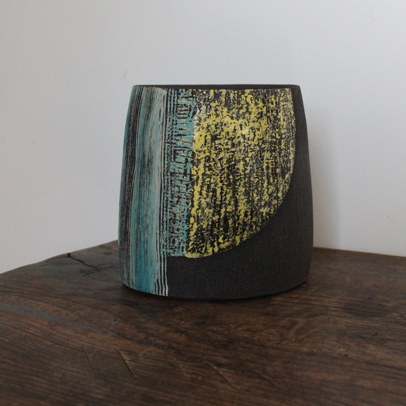 A ceramic vessel with yellow and blue glaze by Cornish artist Anthea Bowen.