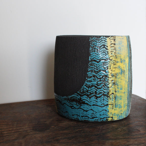 A hand built ceramic vessel with yellow and blue glaze by Cornish artist Anthea Bowen.