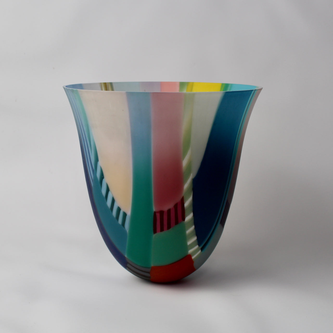 tall and gently curved multi-coloured glass vase  it is made by Ruth Shelley