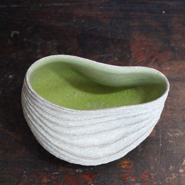 slumped carved with rib design stoneware bowl with a lime green interior glaze by UK ceramic artist Michele Bianco 