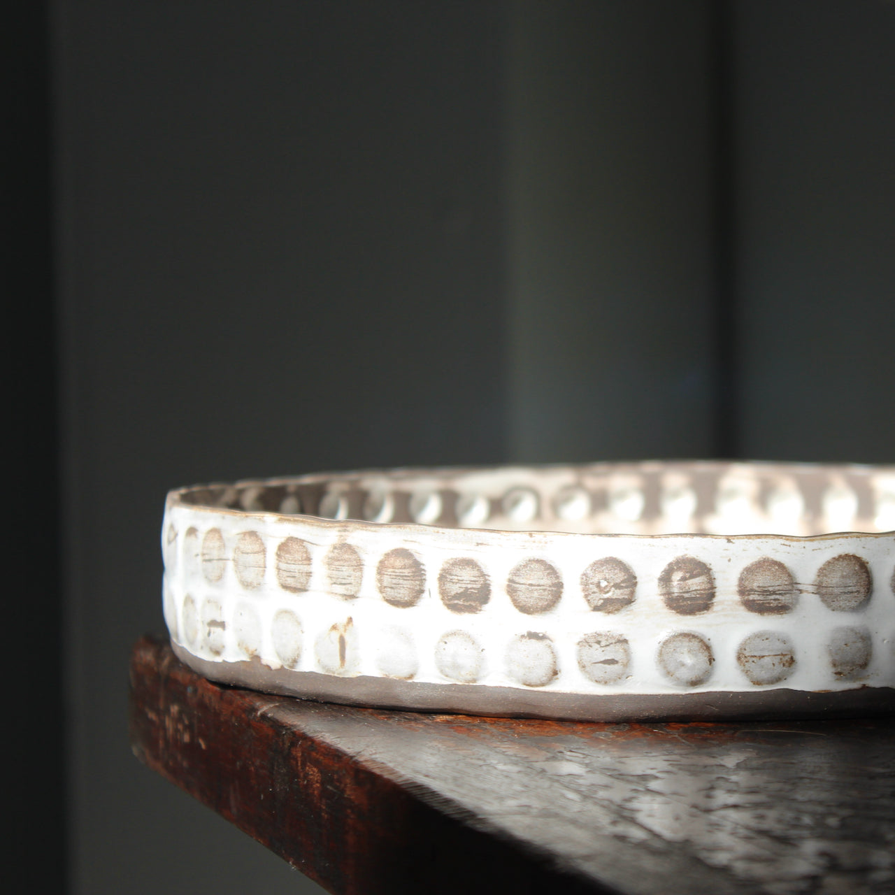 a white and brown textured platter by UK ceramicist Elly Wall.
