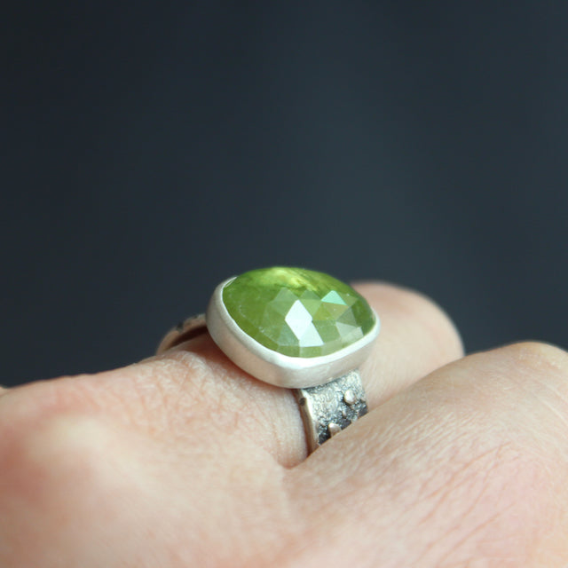 Sphene ring in textured sterling silver by Carin Lindberg on finger