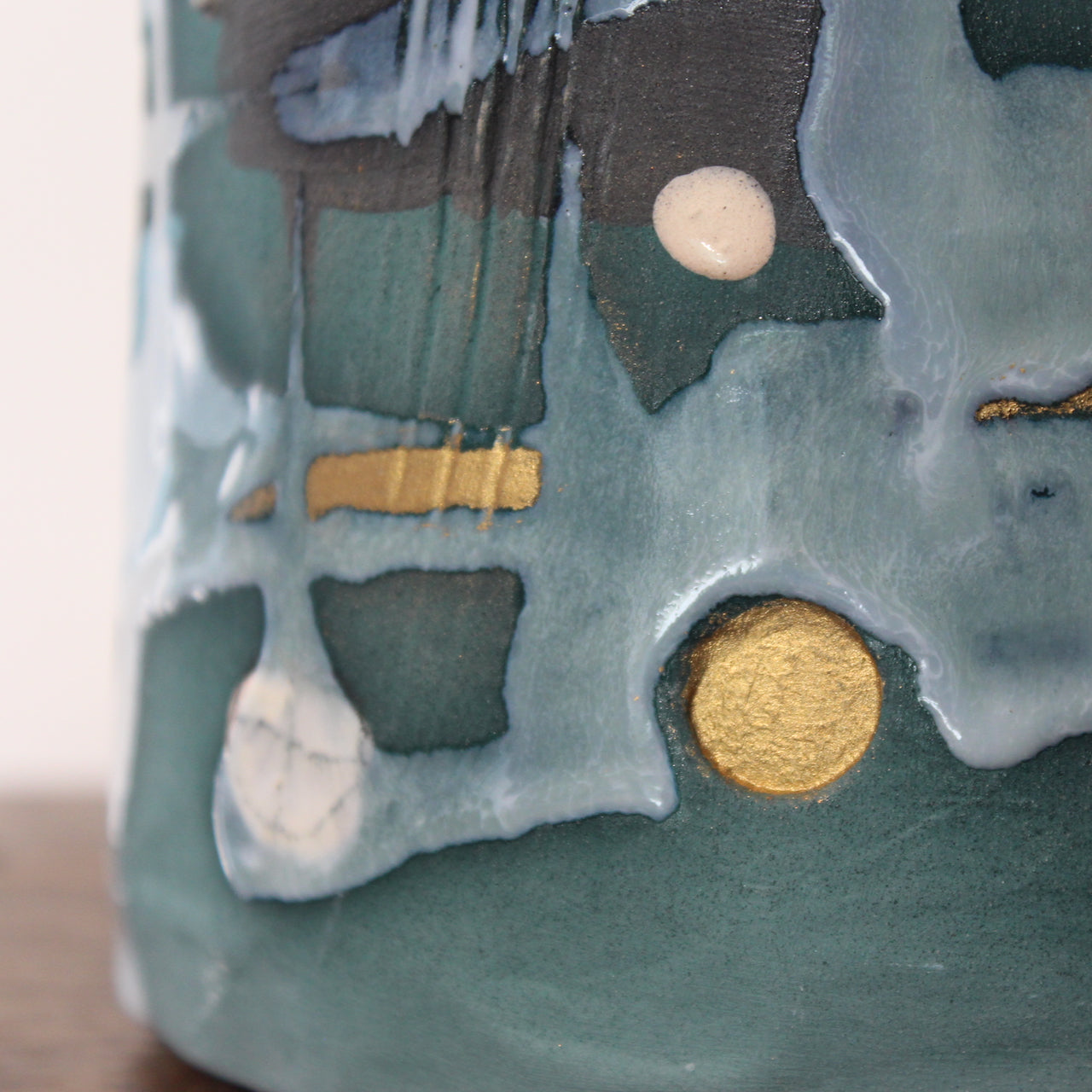 close up detail of a textured green and blue ceramic bottle by Dawn Hajittofi, UK ceramicist