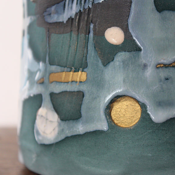close up detail of a textured green and blue ceramic bottle by Dawn Hajittofi, UK ceramicist 