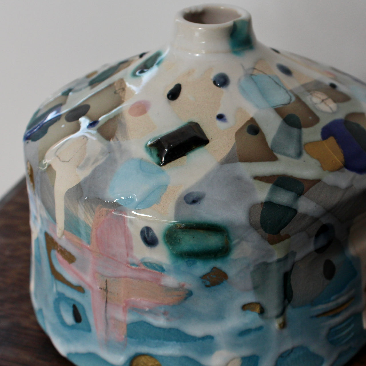 a squat pink and blue ceramic bottle by ceramicist Dawn Hajittofi.