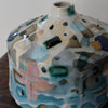a squat pink and blue ceramic bottle by ceramicist Dawn Hajittofi.