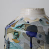 close up of the decoration on a small ceramic  bottle in blue, grey and green by UK ceramicist Dawn Hajittofi