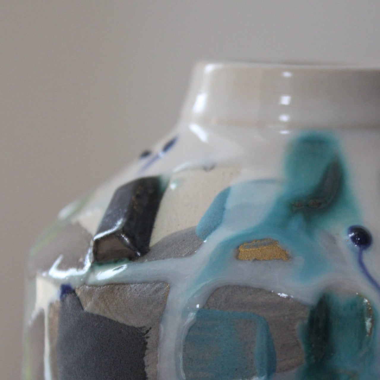 close up detail of green and blue ceramic bottle  by Uk ceramicist Dawn Hajittofi.